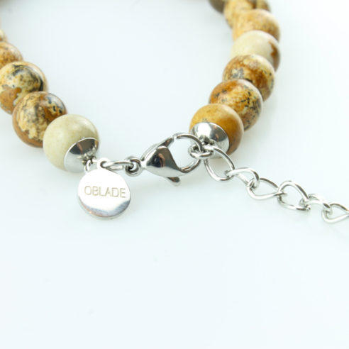 Bracelet pour homme composé de perles de jaspe scénique et de pierres rutile naturelles.