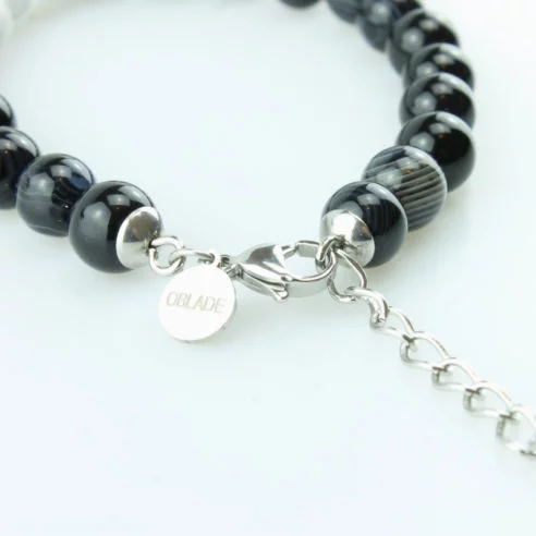 Bracelet pour homme composé de perles d'agate noires rayées et de trois pierres de howlite naturelles.